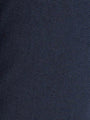 Close-up of dark blue denim fabric showing fine dotted texture and weave – Wam Denim.
