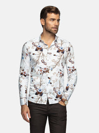 Man wearing a floral patterned shirt on a plain background