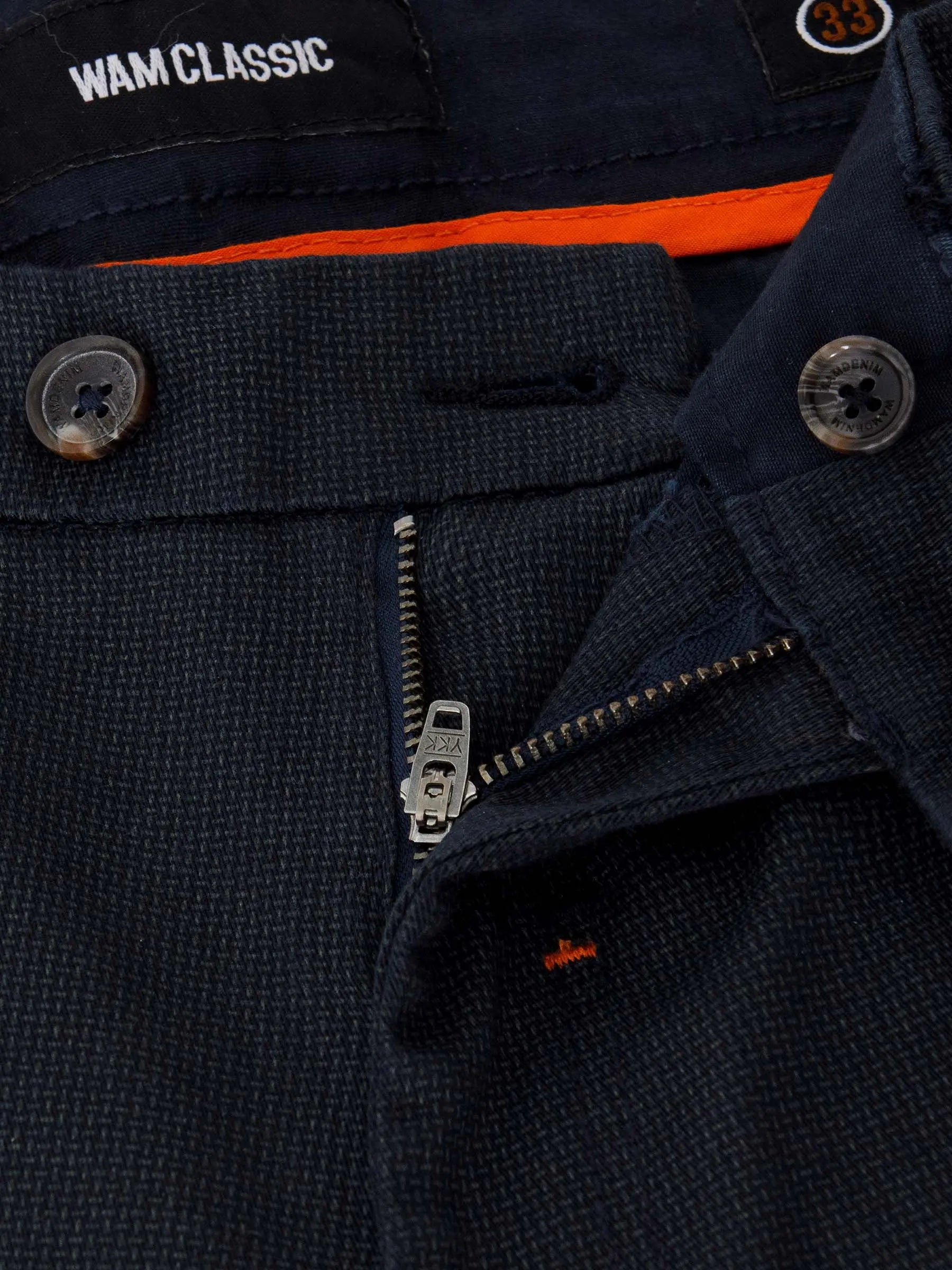 Close-up of navy textured chinos showing zipper, button, and Wam Classic label – Wam Denim.