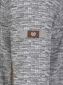 
Close-up of the W-shield sleeve logo on the textured grey sweater – Wam Denim.