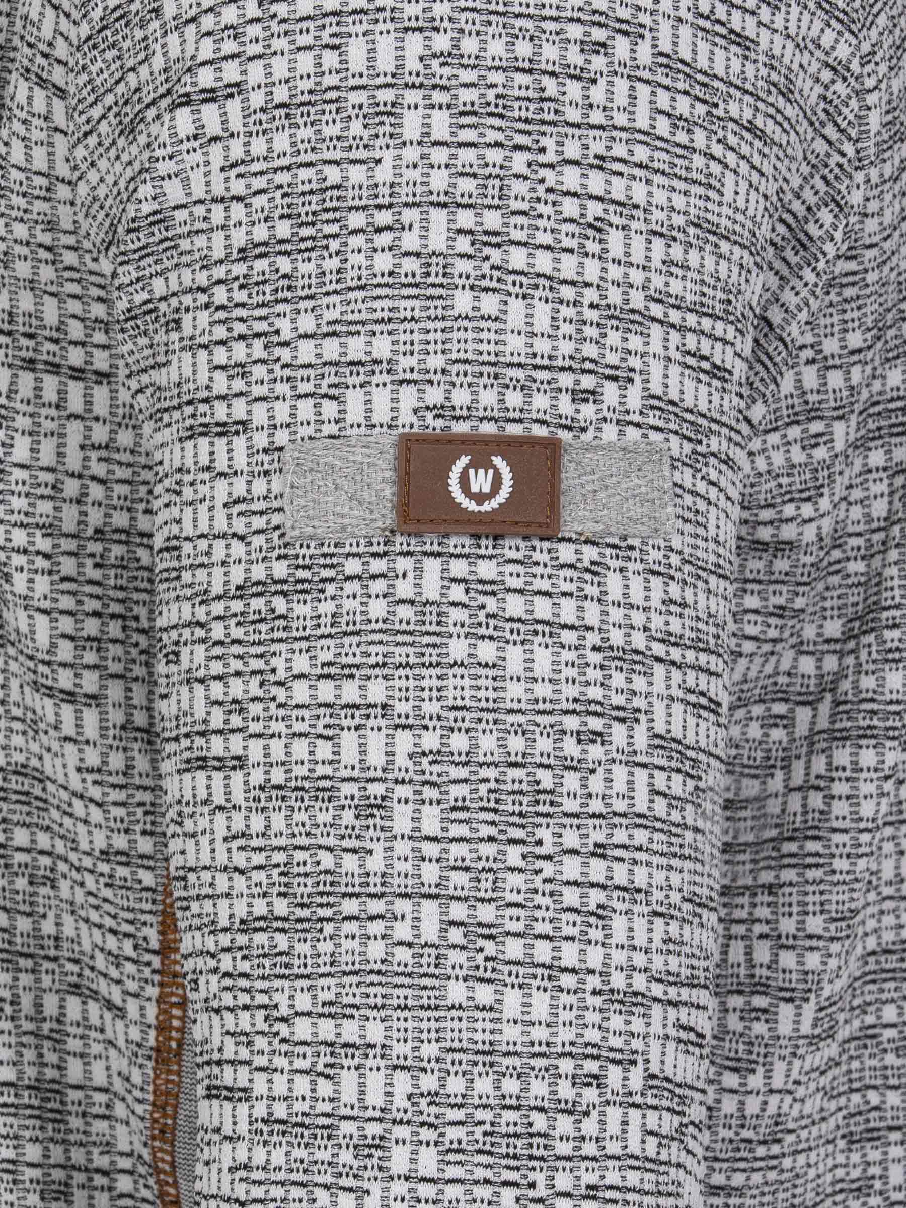 
Close-up of the W-shield sleeve logo on the textured grey sweater – Wam Denim.