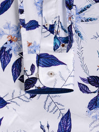 Close-up of blue floral print shirt cuff with button and fine stitching detail – Wam Denim.