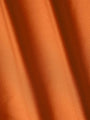 Close-up of smooth orange fabric highlighting soft texture and premium quality – Wam Denim.