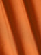 Close-up of smooth orange fabric highlighting soft texture and premium quality – Wam Denim.