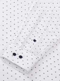 Close-up of white shirt sleeve with navy buttons and dotted pattern detailing – Wam Denim.