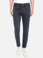 Man wearing dark blue slim-fit jeans with white sneakers. – Wam Denim.
