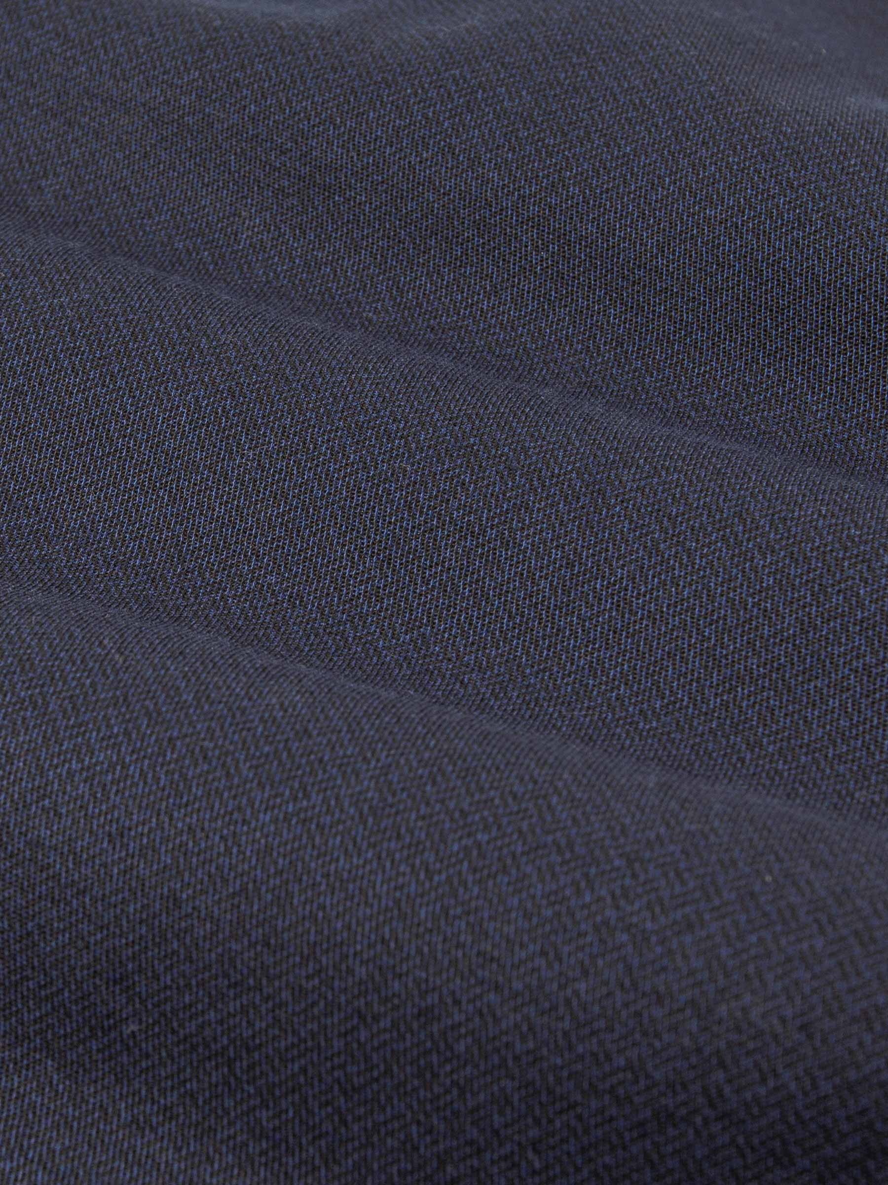 Close-up of dark blue denim fabric with textured weave. – Wam Denim.