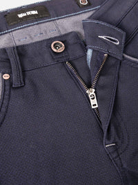 Close-up of dark blue jeans waistband with branded label. – Wam Denim.