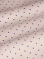 Close-up of beige fabric with purple dot pattern, textured. – Wam Denim.