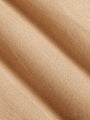 Close-up of beige fabric with subtle texture, ideal for clothing. – Wam Denim.