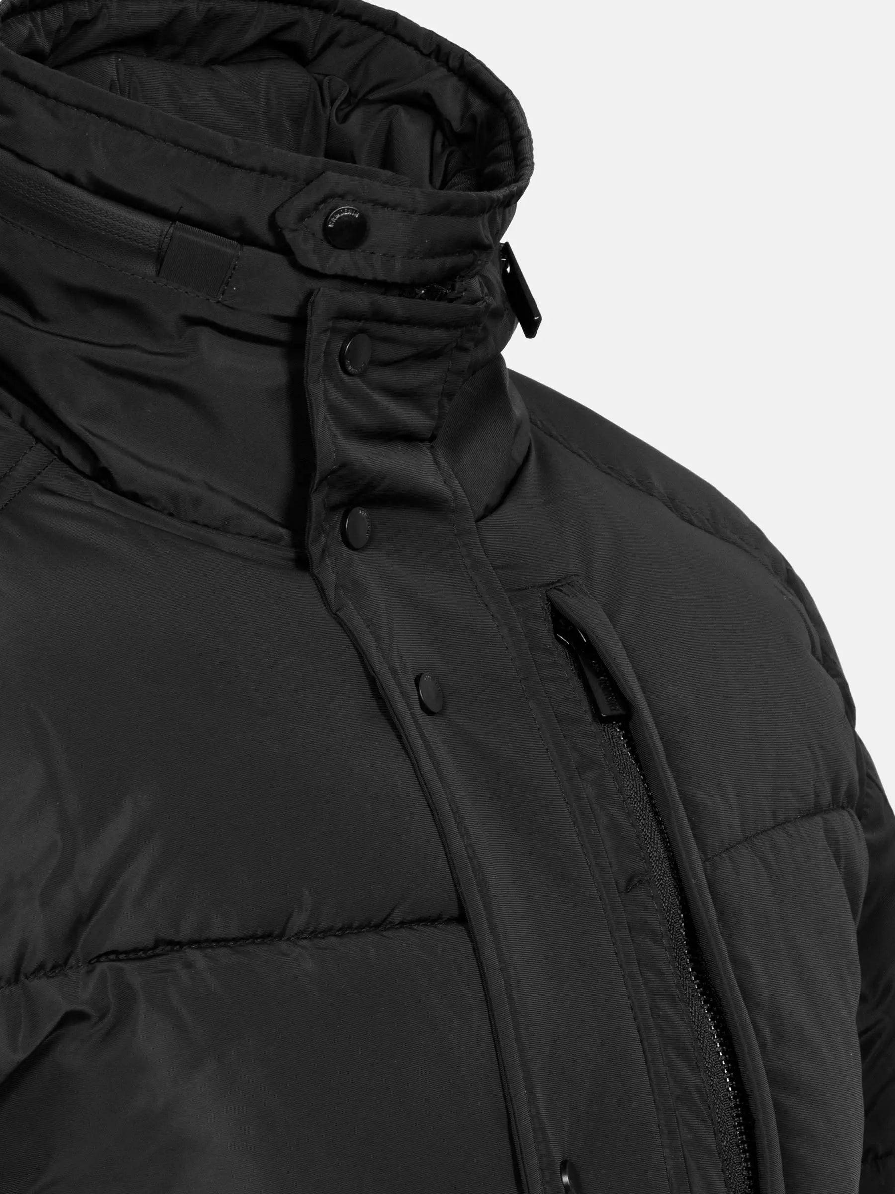 Close-up of the high neck and placket on the black puffer jacket – Wam Denim.