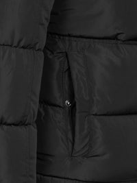 Close-up of the snap-button side pocket on the black puffer – Wam Denim.