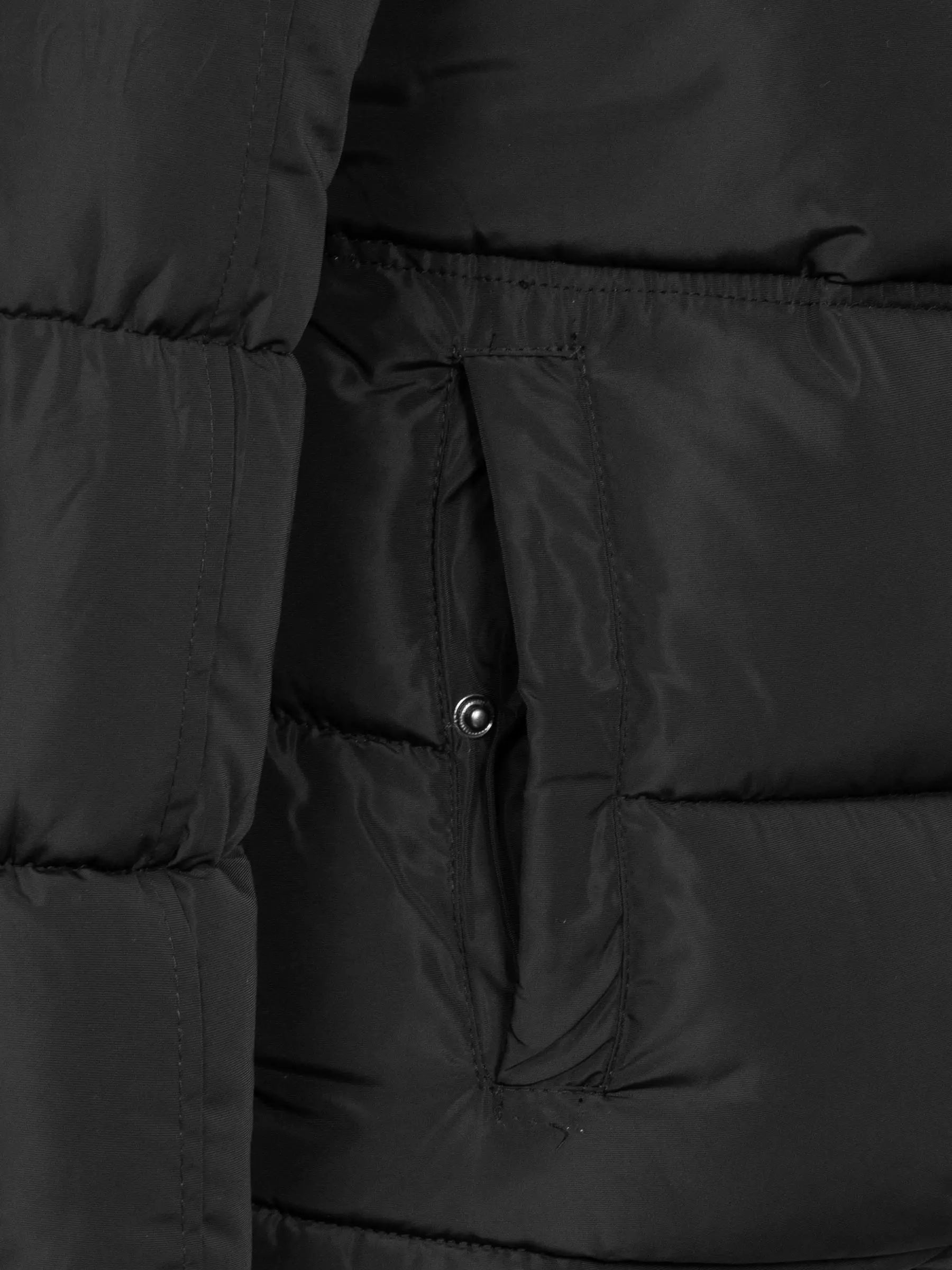 
Close-up of the snap-button side pocket on the black puffer – Wam Denim.