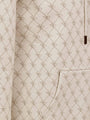 Close-up of beige hoodie pocket with stitched geometric pattern and fine detailing – Wam Denim.