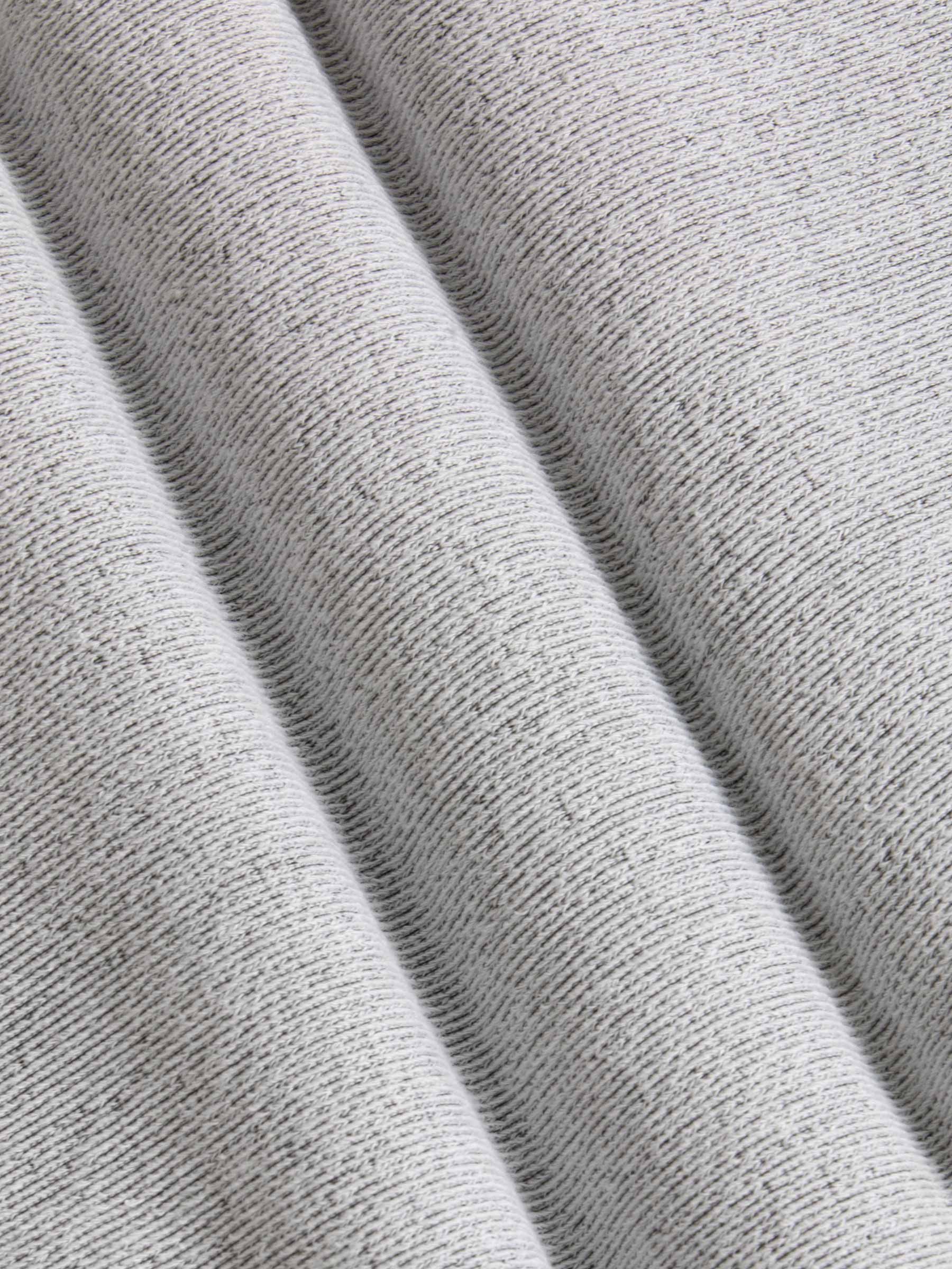 Close-up of textured gray fabric with folds