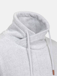 Close-up of a gray sweater with a white background