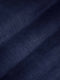 Close-up of dark navy denim fabric texture showing smooth weave and slight fade – Wam Denim.