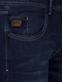 Front pocket close-up of dark navy jeans with leather Wam Denim label and contrast stitching – Wam Denim.