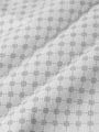 Close-up of grey white Damir Polo fabric pattern. – Wam Denim.