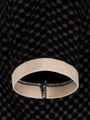 Close-up of polo sleeve showing beige ribbed cuff and geometric black fabric – Wam Denim.