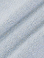 Close-up texture of blue fabric with a geometric pattern – Wam Denim.