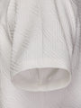 Close-up of the short sleeve on the white textured polo shirt – Wam Denim.
