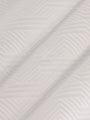 Close-up of the textured white fabric with a geometric pattern – Wam Denim.