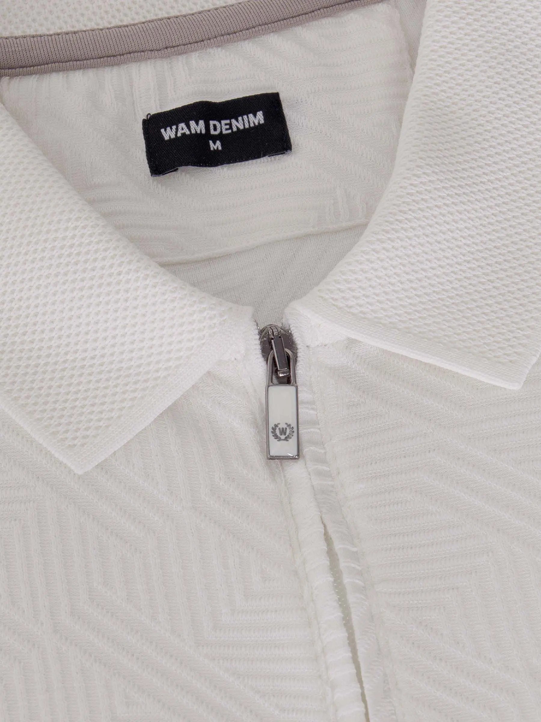 Close-up of the zipper and collar on the white zip polo shirt – Wam Denim.