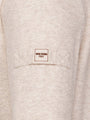 Close-up of a beige garment with a 'WAM Denim Italy' label on a pocket.
