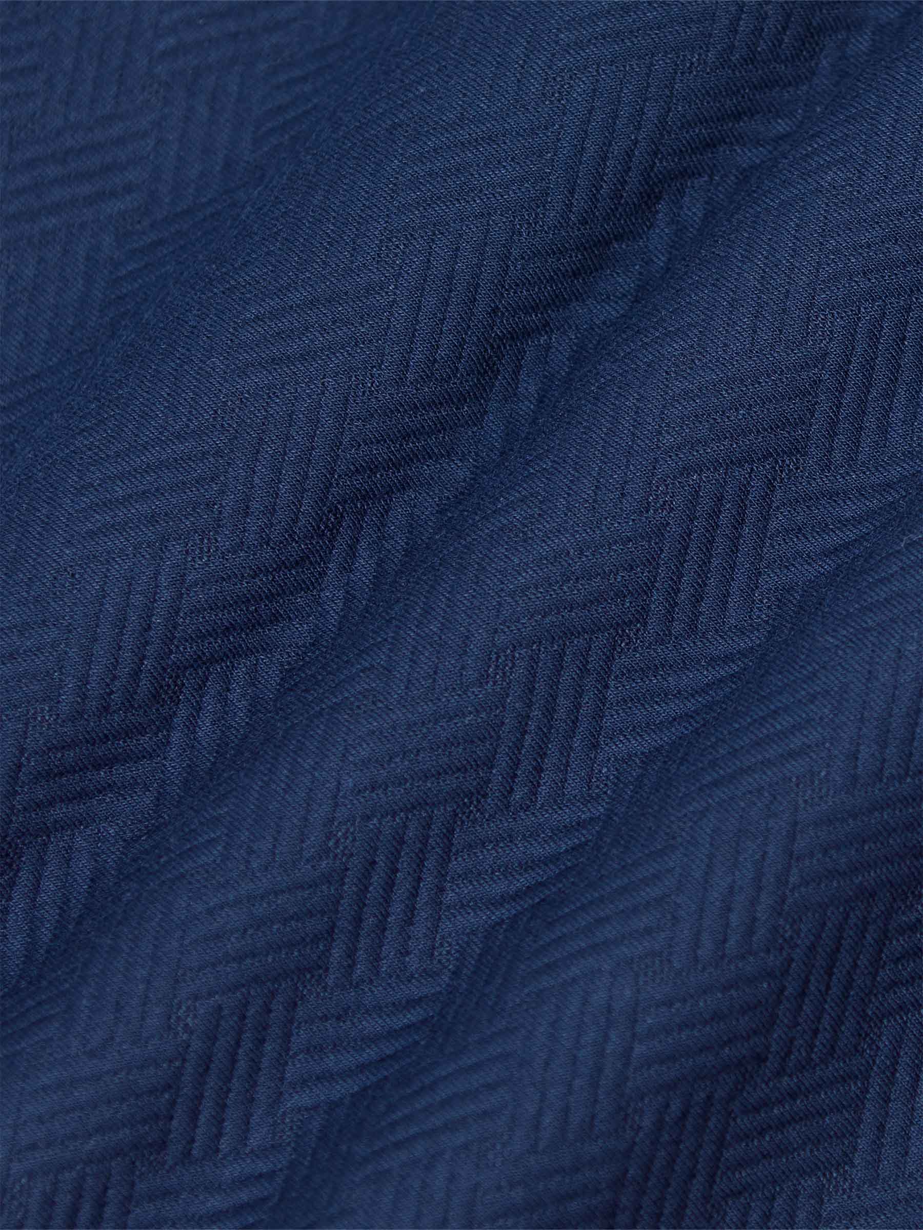 Close-up of textured navy Moorland Sweater fabric. – Wam Denim.