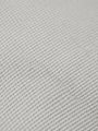 Close-up of light grey pantalon fabric showing fine textured weave pattern.