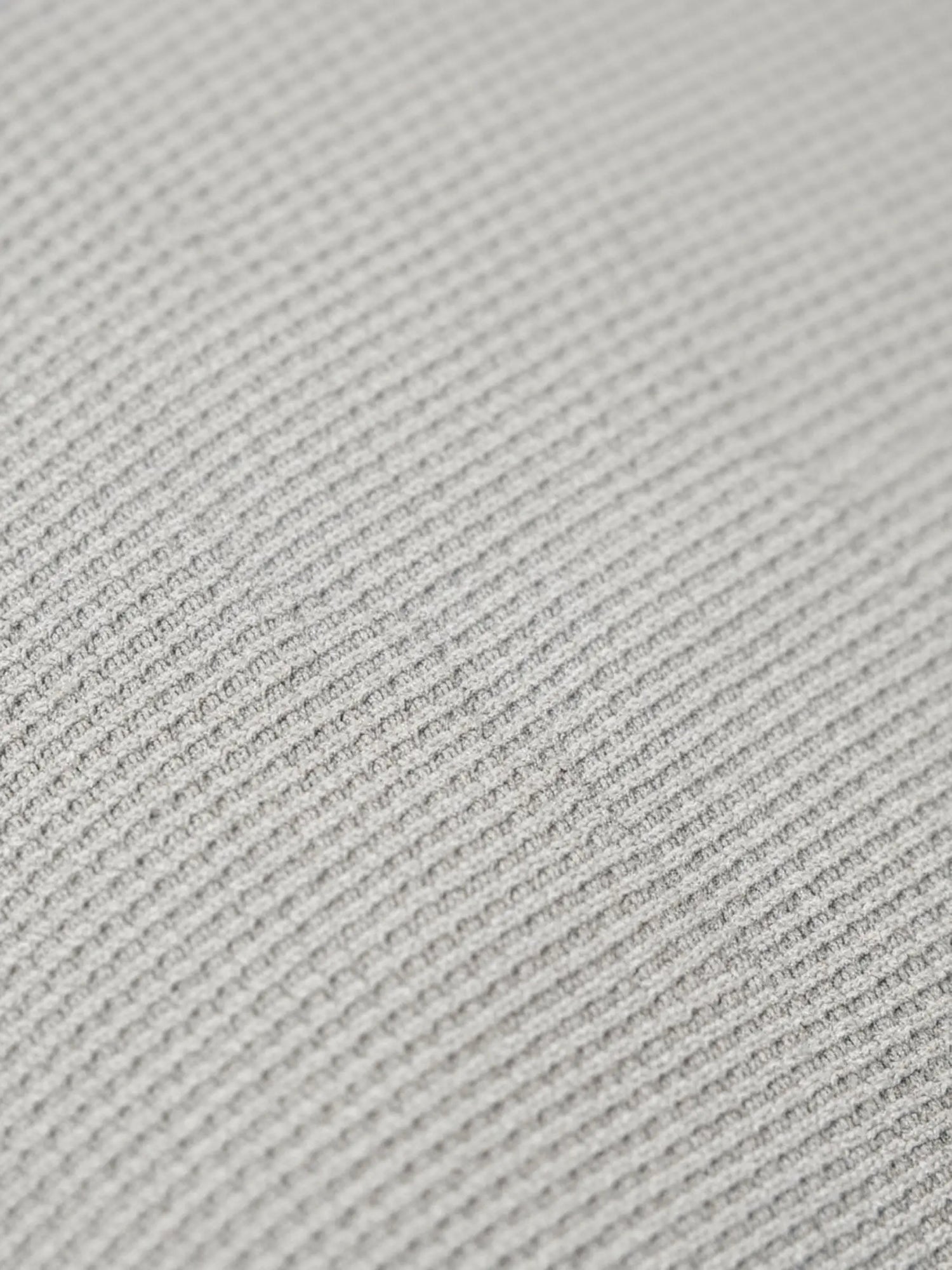 Close-up of light grey pantalon fabric showing fine textured weave pattern.