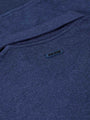 Back collar close-up with embossed Wam Denim logo on light indigo fabric – Wam Denim.