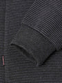Close-up of ribbed Anthracite sweater sleeve with stitched cuff and logo tag – Wam Denim.