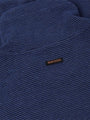 Close-up of the navy knit fabric and Wam Denim label – Wam Denim.