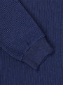 Close-up of the ribbed cuff and navy stripe knit on the sweater – Wam Denim.