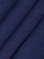 Close-up of the navy blue diagonally ribbed knit fabric – Wam Denim.