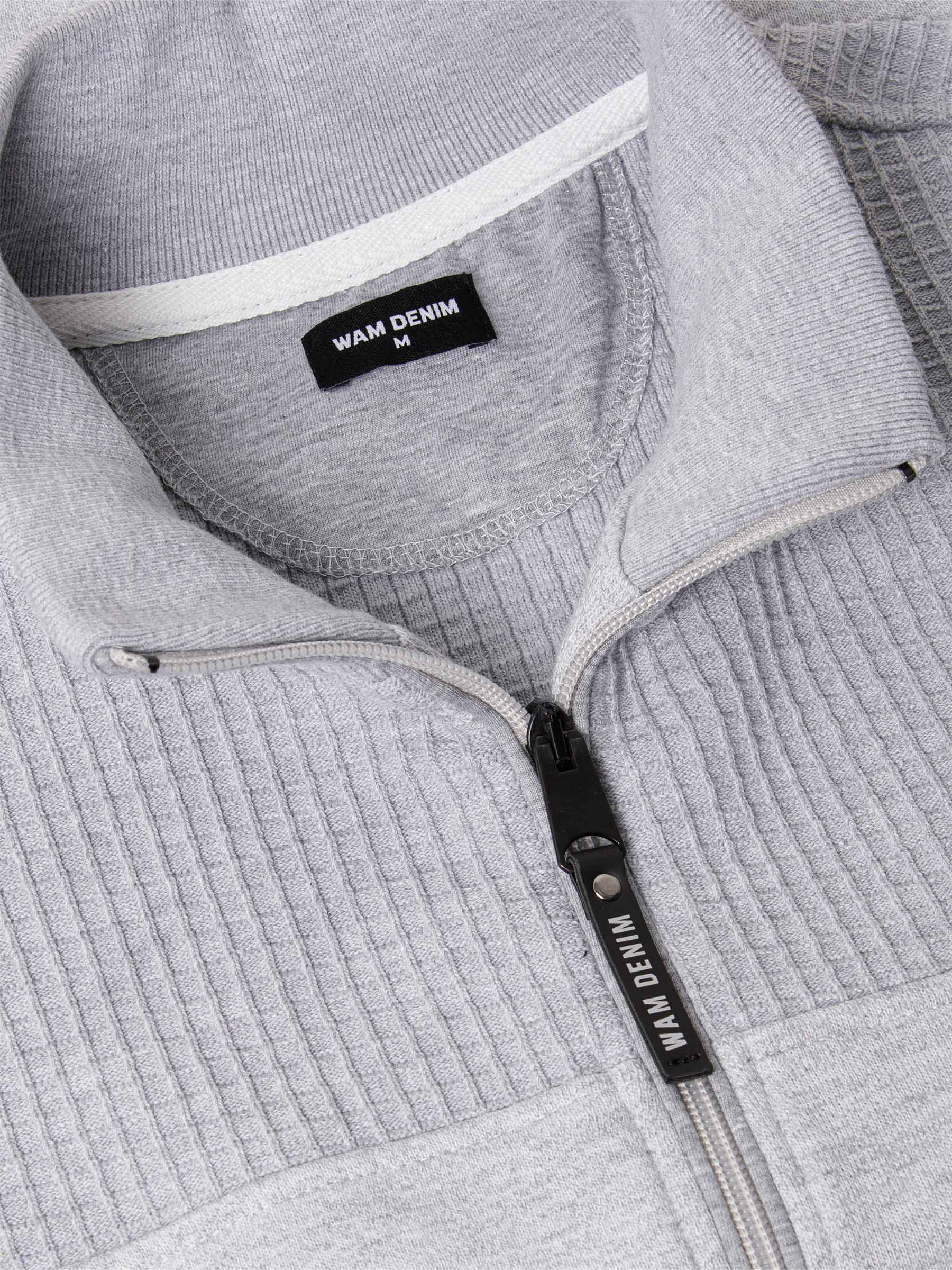 Close-up of The Fletcher Light Grey Vest zipper and ribbed collar detailing with Wam Denim tag – Wam Denim.