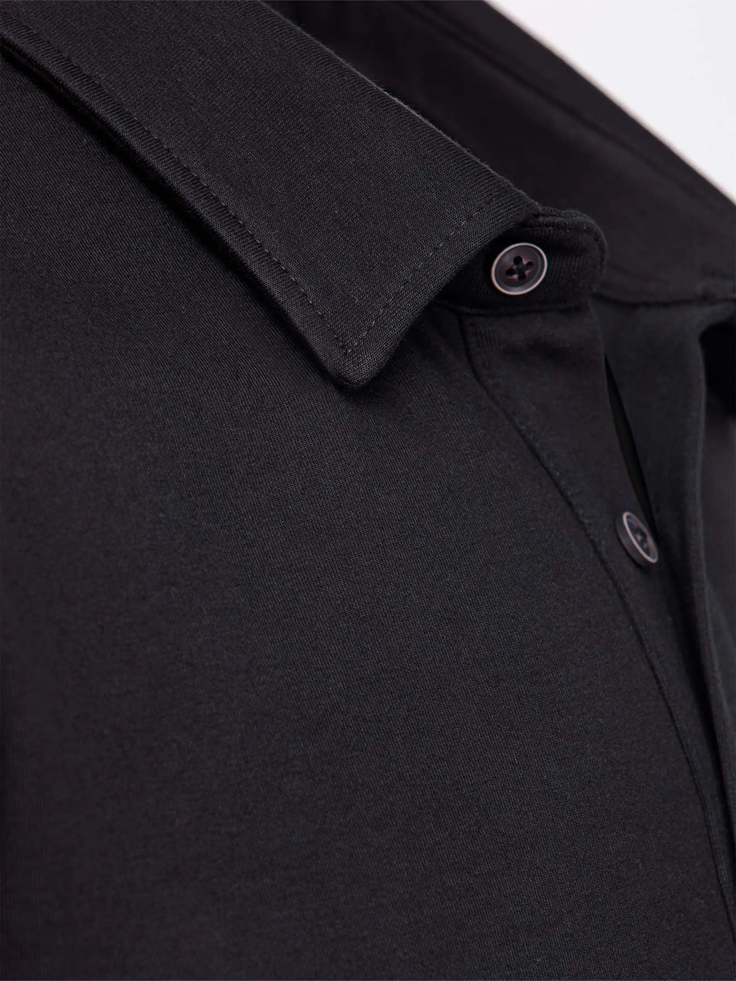 Close-up of The Zeal Black Sweater showing detailed collar stitching and button design – Wam Denim.