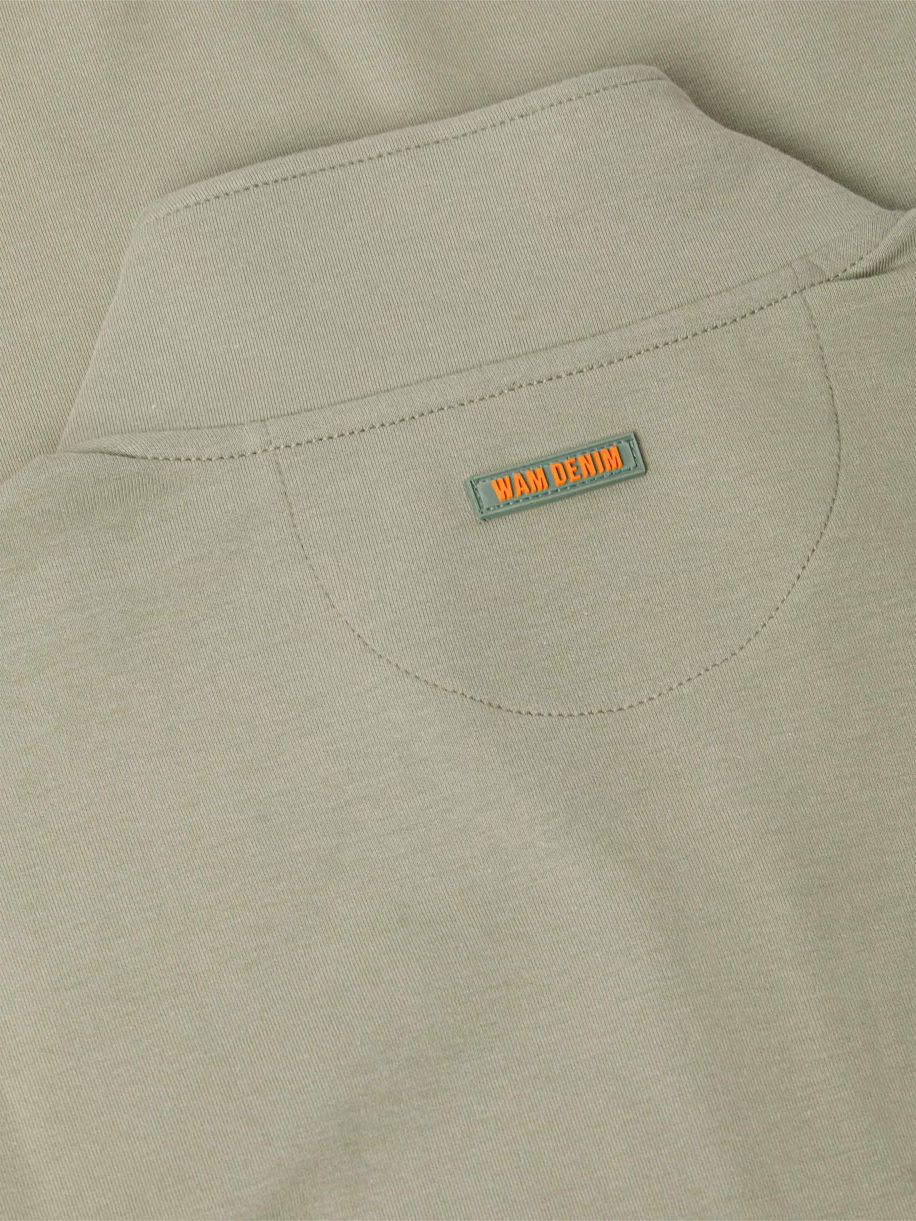 Close-up of a Light Green jacket with a 'WAM Denim' label on the chest pocket.