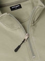 Close-up of a Light Green Sweater with a zipper and 'WAM Denim' label.