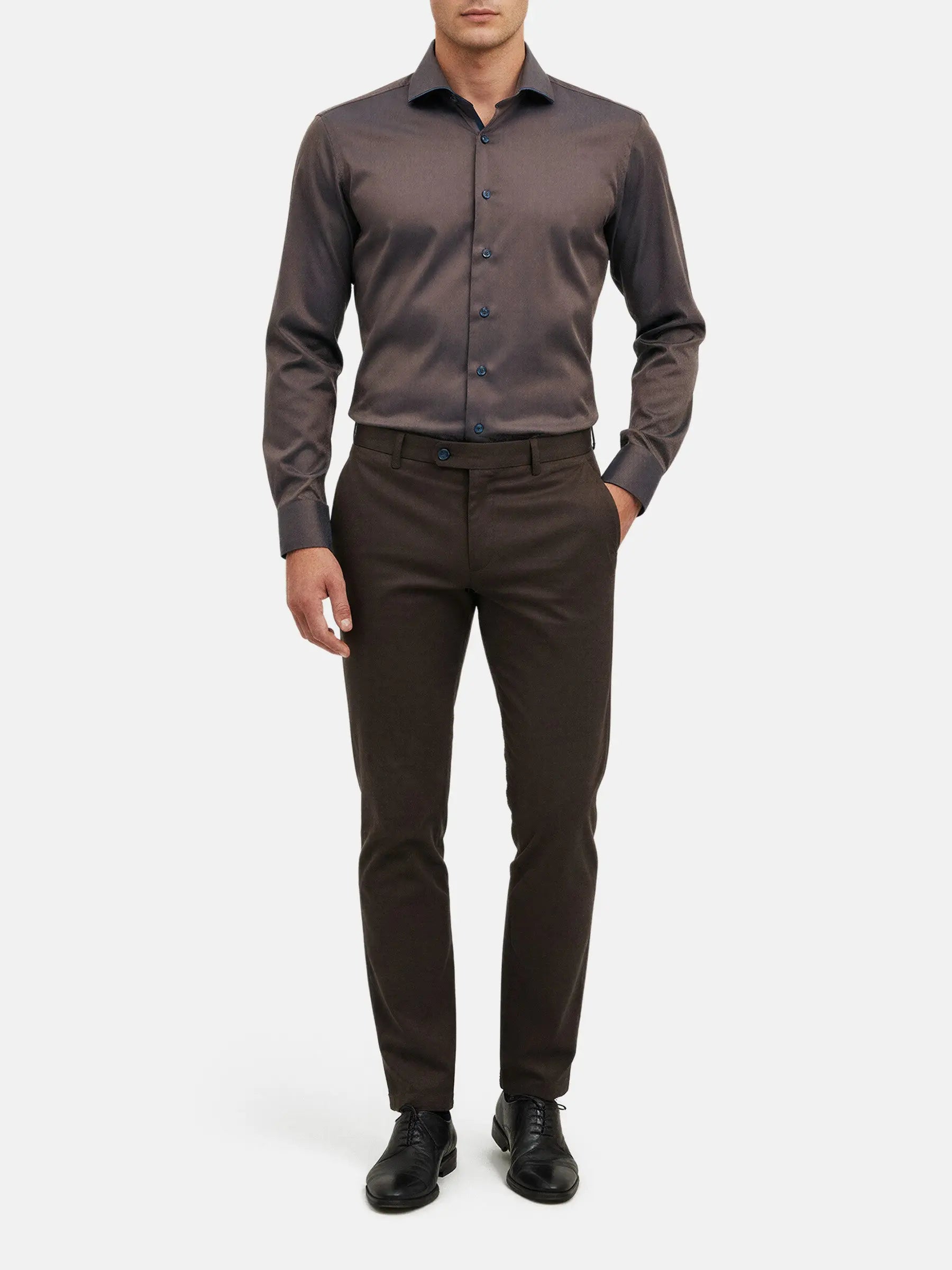 Men wearing light brown slim-fit shirt styled with dark trousers and dress shoes.