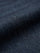 Close-up of navy denim fabric showing smooth weave and premium jean texture.
