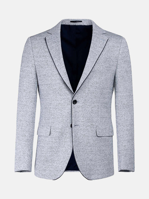 Light white-navy textured blazer with two buttons and notch lapels, modern menswear style.