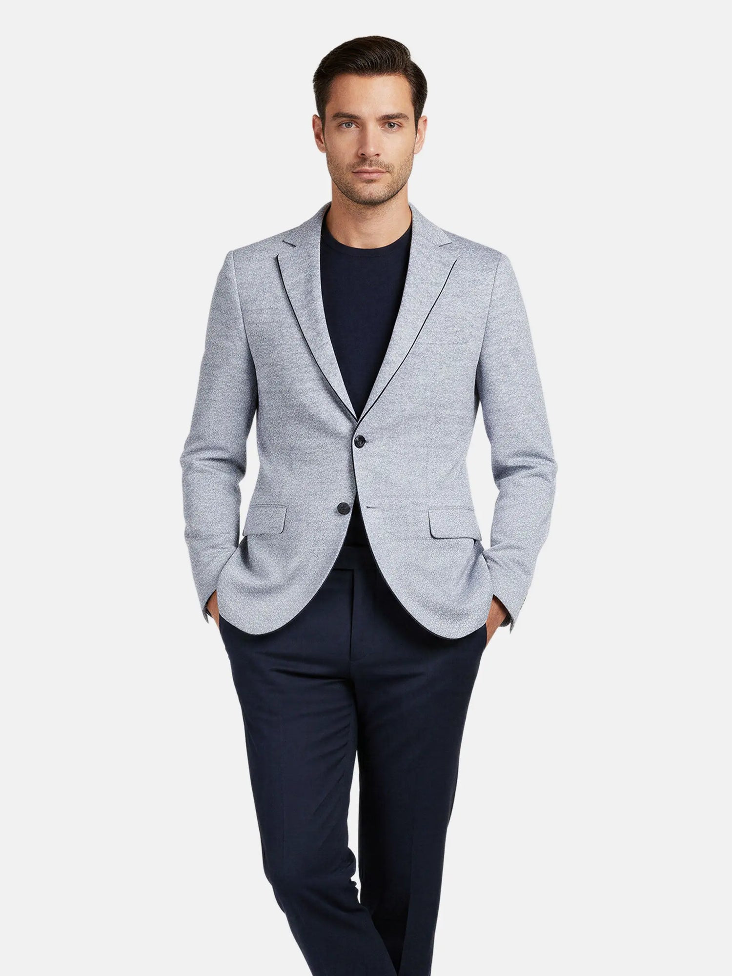 Man wearing the white-navy textured blazer styled with a navy crewneck and trousers.