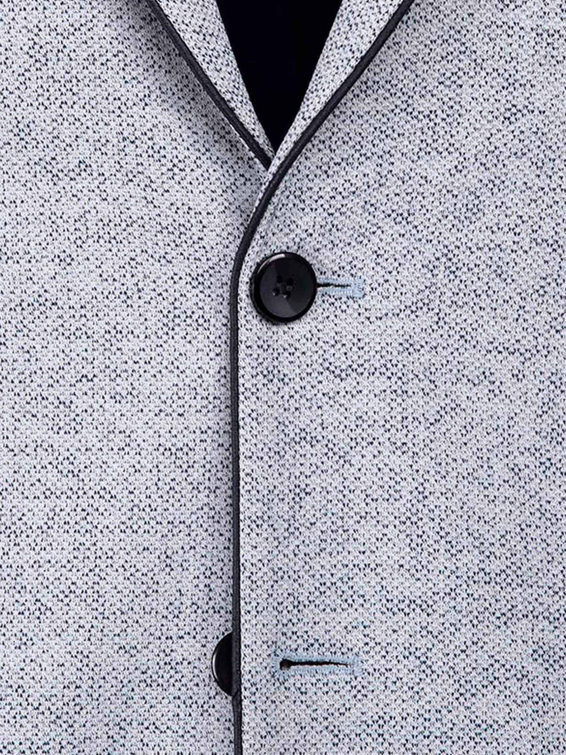 Close-up of the white-navy textured blazer fabric with dark buttons and clean stitching.