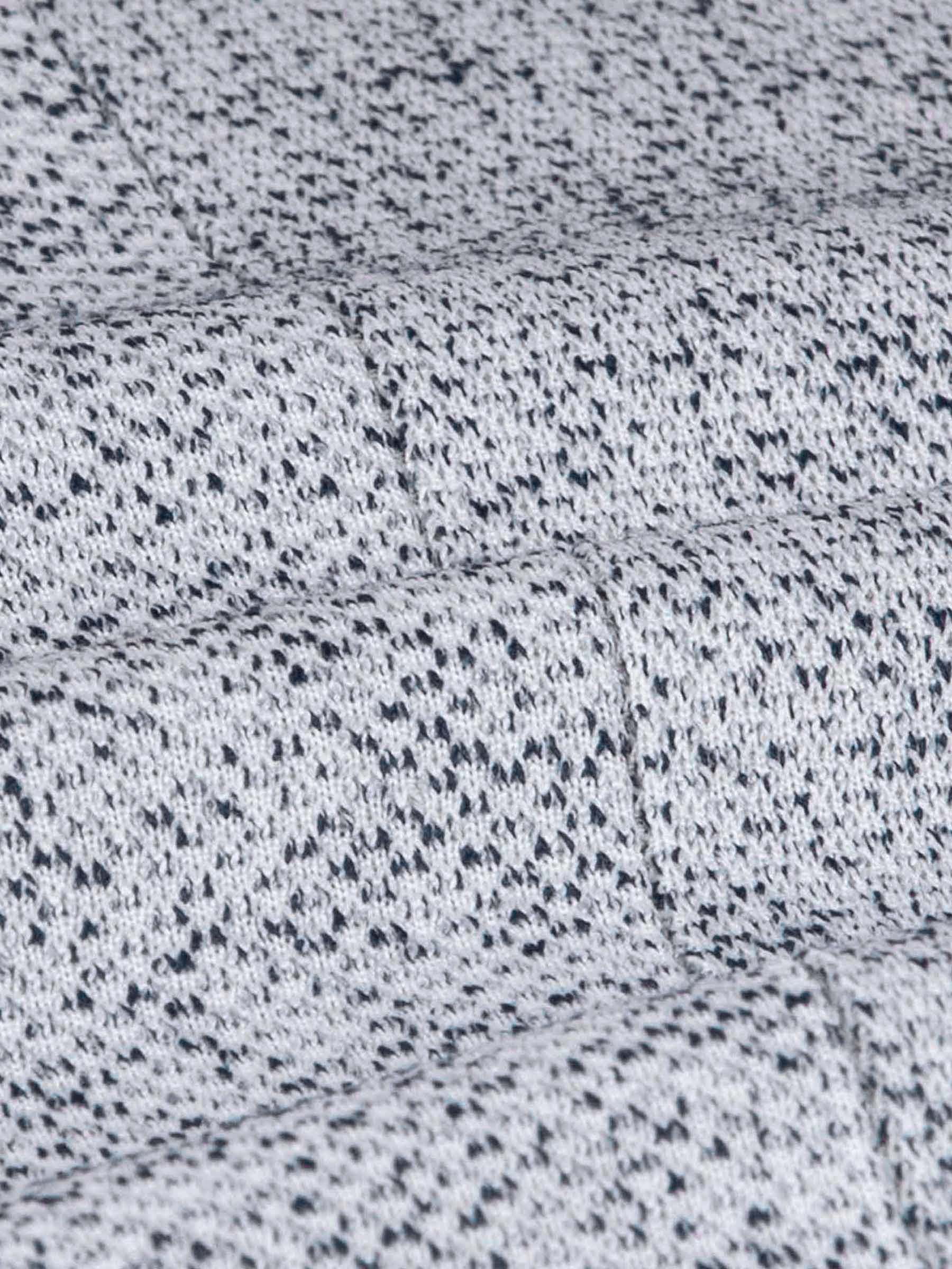 Close-up of the white-navy textured blazer fabric showing its detailed woven pattern.