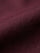 Close-up of dark red men’s shirt fabric showing smooth texture and premium weave