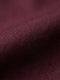Close-up of dark red men’s shirt fabric showing smooth texture and premium weave