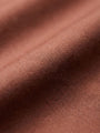 Close-up of light brown men’s shirt fabric showing smooth texture and premium weave
